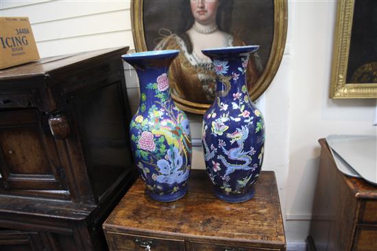 A pair of large Chinese blue ground dragon and phoenix vases, 19th century, restorations